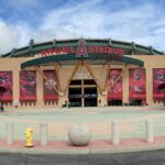 Main entrance of Angel Stadium in Anaheim, California, featuring iconic red cap structures and the Los Angeles Angels logo.